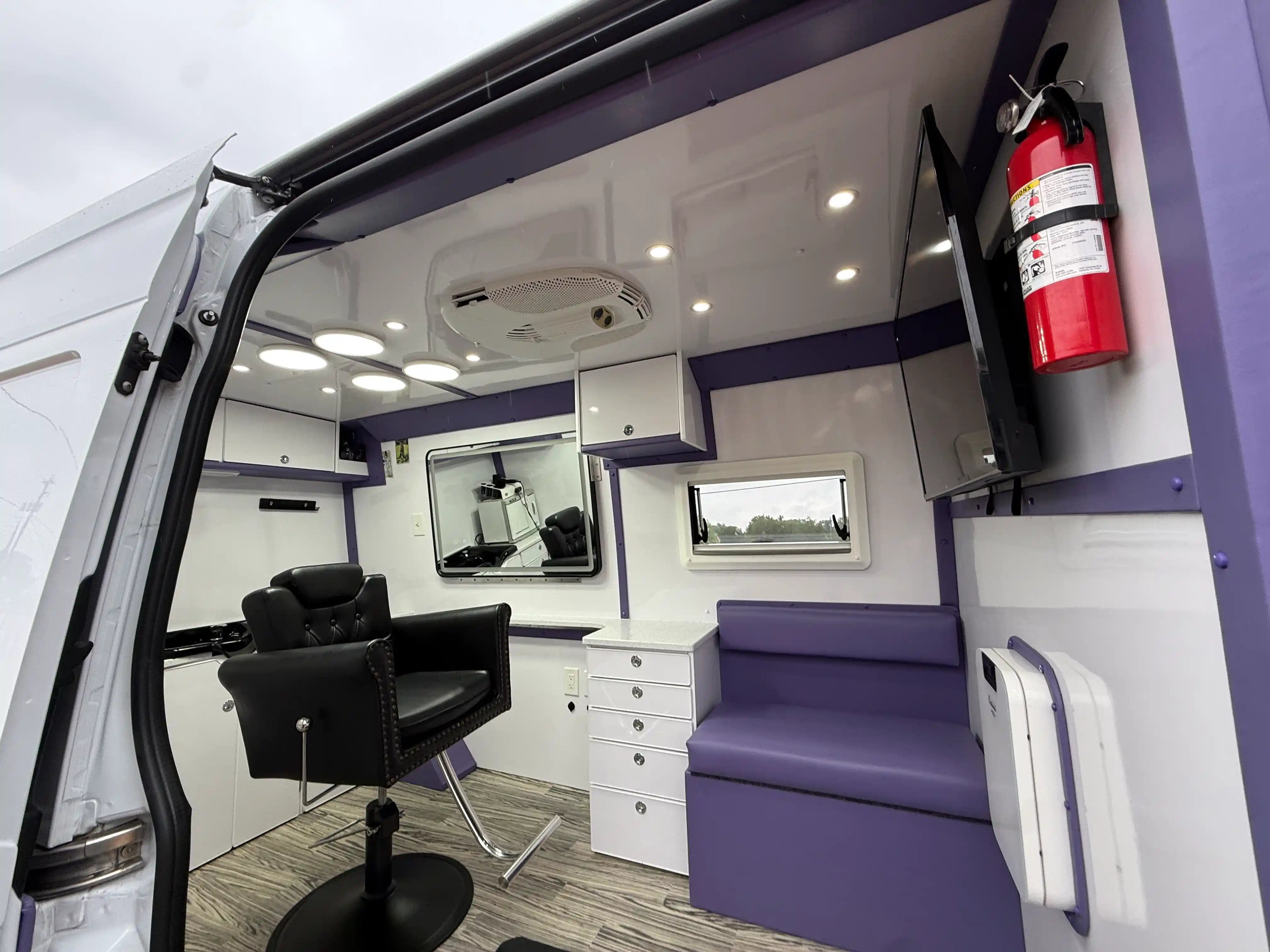 Inside Razor Rick's mobile barbershop van showing barber chair and full setup Austin TX